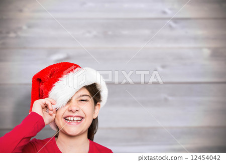 Composite image of festive little girl smiling at camera 12454042