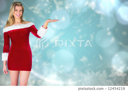 Composite image of pretty girl presenting in santa outfit 12454219