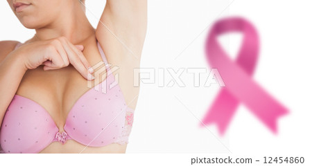Composite image of woman performing self breast examination 12454860