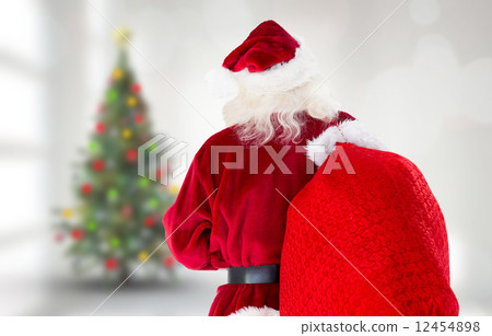 Composite image of santa claus carrying sack Composite image of santa claus carrying sack 12454898
