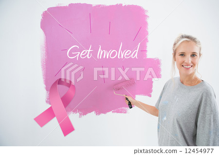 Composite image of happy young woman painting her wall pink Composite image of happy young woman painting her wall pink 12454977