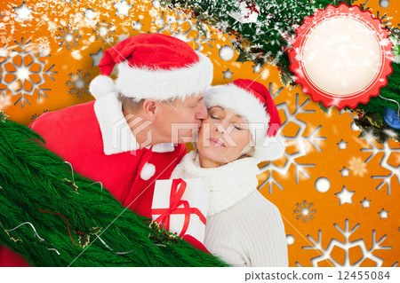 Composite image of festive mature couple holding gift 12455084