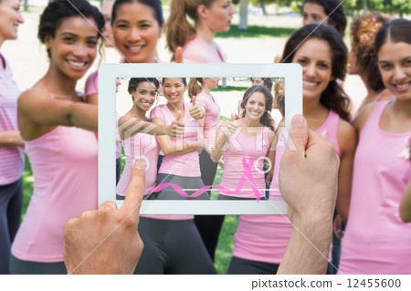 Composite image of hand holding tablet pc 12455600