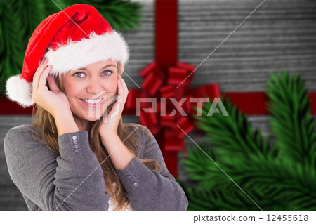 Composite image of festive blonde smiling at camera Composite image of festive blonde smiling at camera 12455618
