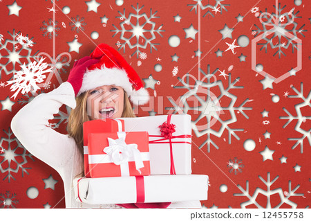 Composite image of festive blonde holding pile of gifts Composite image of festive blonde holding pile of gifts 12455758