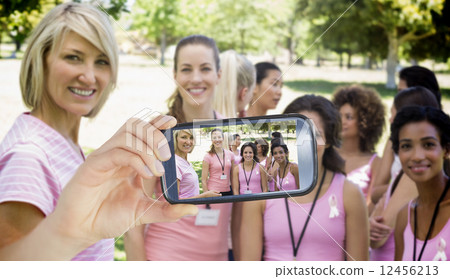 Composite image of hand holding smartphone showing 12456213