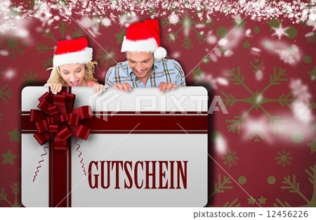 Composite image of young festive couple 12456226