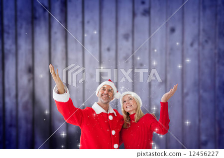 Composite image of festive couple 12456227