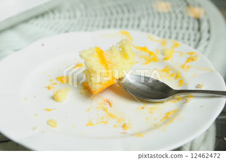 Soiled cake plates on rattan table 12462472