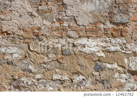 Ancient red brick wall with remaining plaster spots 12462782