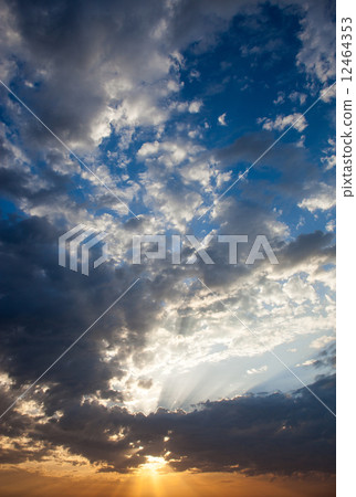 Cloudscape with the sun rays radiating from behind the cloud Cloudscape with the sun rays radiating from behind the cloud 12464353