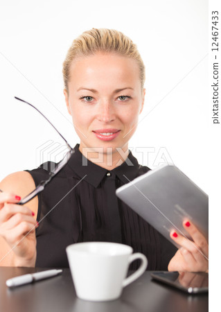 Business woman working on tablet PC. 12467433