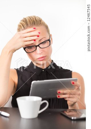 Business woman working on tablet PC. 12467545