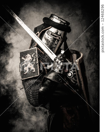 Medieval knight with a sword against stone wall Medieval knight with a sword against stone wall 12468296