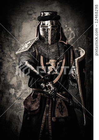 Medieval knight with a sword against stone wall Medieval knight with a sword against stone wall 12468298