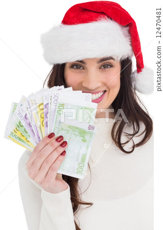 Festive brunette holding her cash 12470481