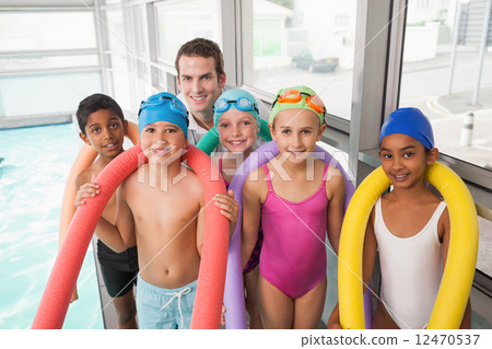 Swimming coach with his students poolside Swimming coach with his students poolside 12470537