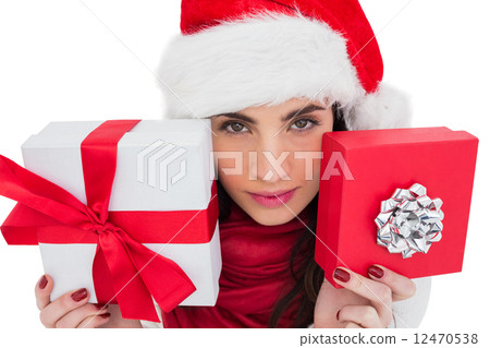 Pretty brunette showing christmas gifts 12470538