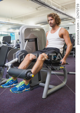 Young man doing leg workout at gym 12470739