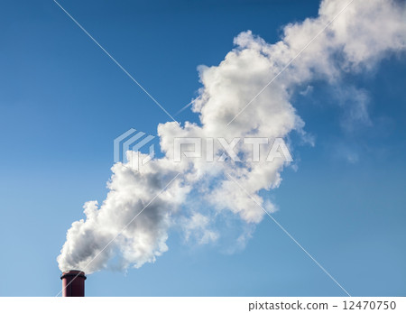 Smoke from industrial smokestack on a clear blue sky. 12470750
