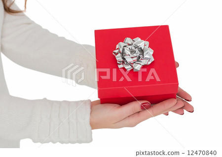 Woman with nail varnish holding red gift Woman with nail varnish holding red gift 12470840
