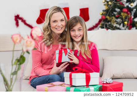 Festive mother and daughter with gift Festive mother and daughter with gift 12470952