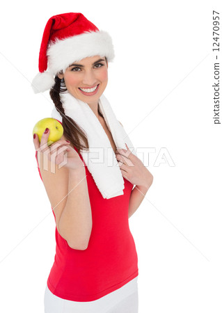 Festive fit brunette holding apple 12470957