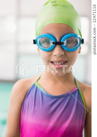 Cute little girl standing poolside 12471118
