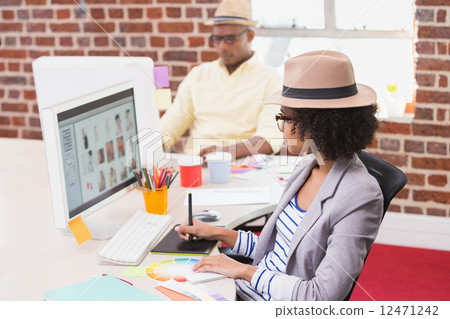 Female photo editor using digitizer in office Female photo editor using digitizer in office 12471242