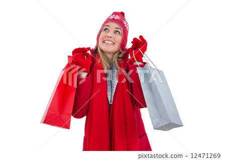 Blonde in winter clothes holding shopping bags Blonde in winter clothes holding shopping bags 12471269