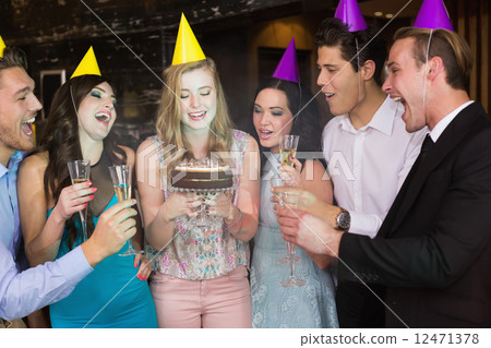 Attractive friends celebrating a birthday Attractive friends celebrating a birthday 12471378
