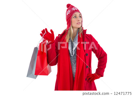 Blonde in winter clothes holding shopping bags Blonde in winter clothes holding shopping bags 12471775