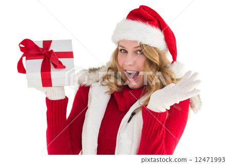 Excited blonde in santa hat holding gift 12471993
