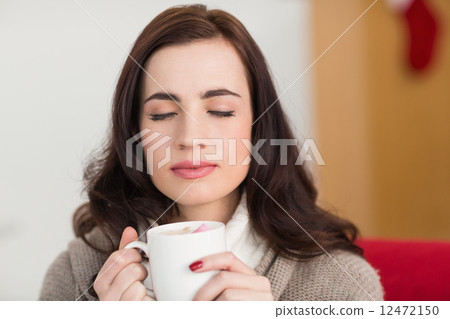 Brunette enjoying a hot chocolate with marshmallow Brunette enjoying a hot chocolate with marshmallow 12472150