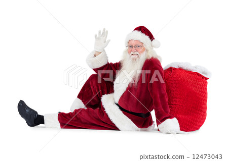 Santa sits leaned on his bag and waves Santa sits leaned on his bag and waves 12473043