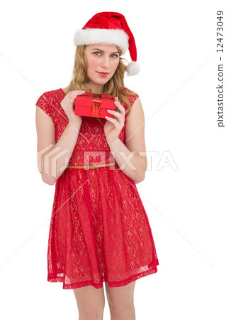 Blonde woman in santa hat standing with gift Blonde woman in santa hat standing with gift 12473049
