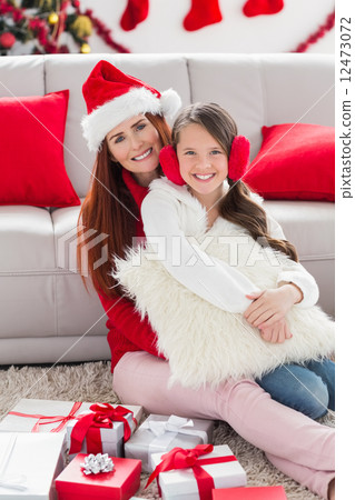 Festive mother and daughter smiling at camera 12473072