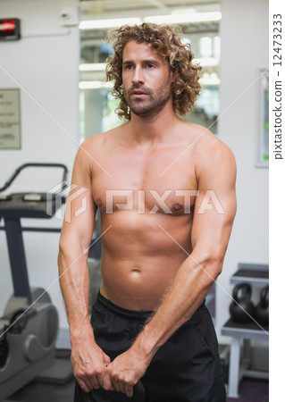 Shirtless man exercising with kettle bell Shirtless man exercising with kettle bell 12473233