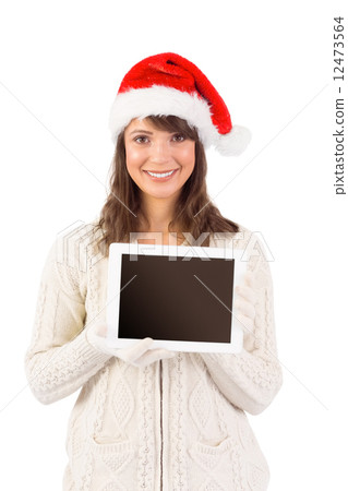Festive brunette holding a tablet pc 12473564