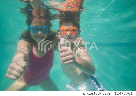 Cute kids posing underwater in pool 12473761
