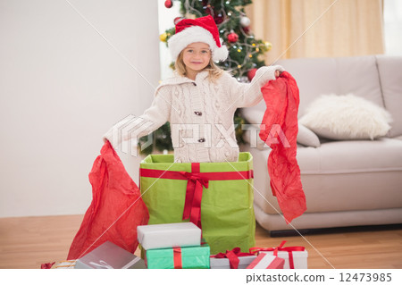 Cute little girl sitting in giant christmas gift Cute little girl sitting in giant christmas gift 12473985