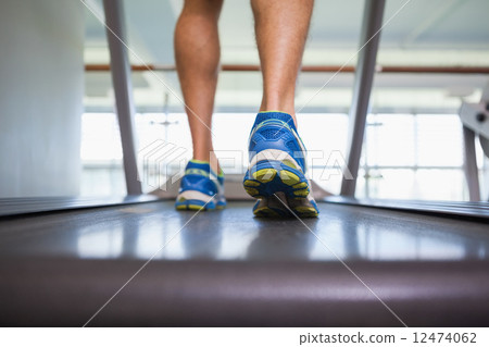 Low section of a man running on treadmill 12474062