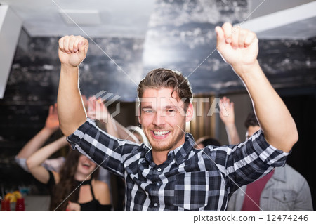 Stylish man smiling and dancing 12474246