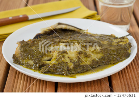 fish with sauce pesto on th plate 12476631