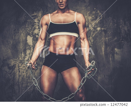 Muscular bodybuilder woman holding chains 12477042
