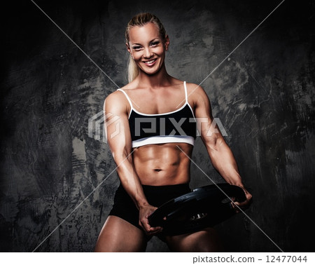 Beautiful muscular bodybuilder woman with weights 12477044
