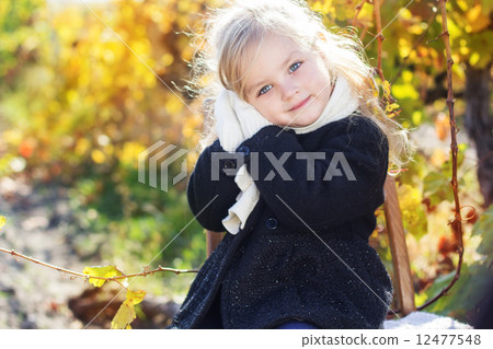 Adorable little girl in warm clothes, autumn time Adorable little girl in warm clothes, autumn time 12477548