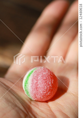 A large candy ball in the palm of your hand A large candy ball in the palm of your hand 12480618