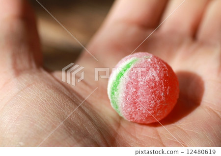 A large candy ball in the palm of your hand A large candy ball in the palm of your hand 12480619
