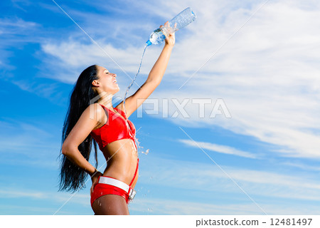 sport girl in red uniform with a bottle of water sport girl in red uniform with a bottle of water 12481497